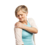 Senior woman with shoulder pain, isolated on white background
